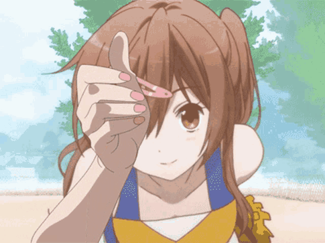 a girl in a cheerleader outfit is holding a hair clip in her hand