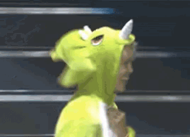 a person wearing a green costume with horns