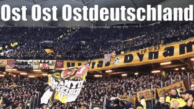 a large crowd of people in a stadium with the words ost ost ost deutschland