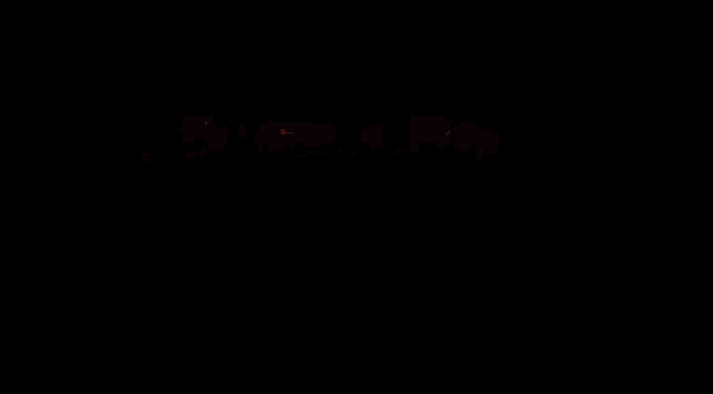 a silhouette of a person holding a microphone is glowing in the dark .