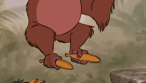 a cartoon monkey is holding a banana peel in his hand