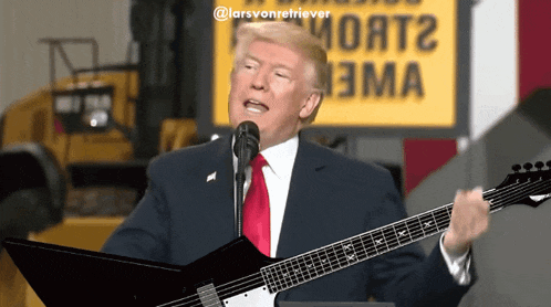 donald trump is singing into a microphone while playing a guitar