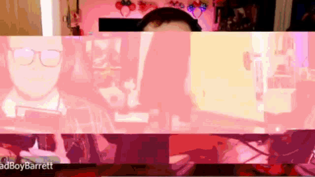 a man wearing glasses and headphones is behind a pink screen that says adboybarrett