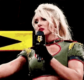 a woman is holding a microphone with the letter n on it .