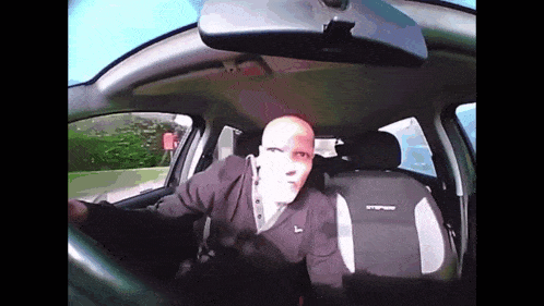 a man driving a car with a mask on his face