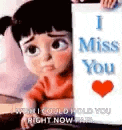 a little girl is holding a sign that says `` i miss you '' and a heart .