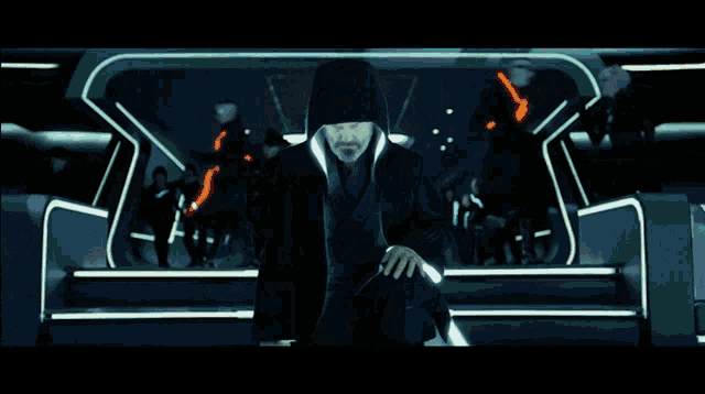 a man with a hood on his head is standing in a room