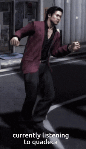 a man in a red jacket is currently listening to quadec