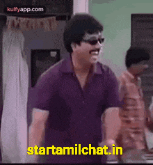 a man wearing sunglasses and a purple shirt is standing in a room and says starttamilchat.in