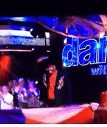 a man stands in front of a sign that says ' dallas ' on it
