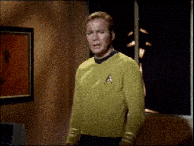 a man wearing a yellow sweater with the letter a on his chest