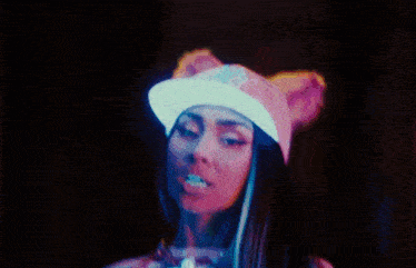 a woman wearing a cat ears hat and a pink shirt
