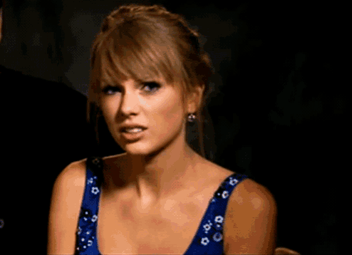 a woman in a blue dress making a face
