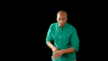 a man in a green shirt is talking to a woman in a yellow sweater