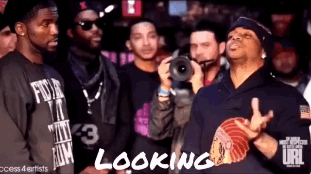 a group of men are standing in front of a camera with the caption looking