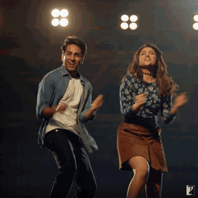 a man and a woman are dancing in front of a sign that says p.