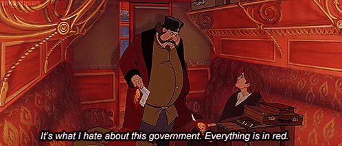 a man in a red coat is talking to another man in a red room ..