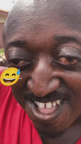 a close up of a man 's face with a smiley face on his forehead