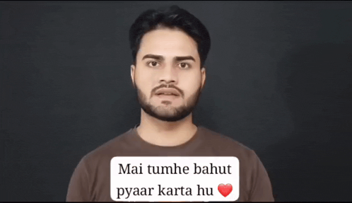 a man with a beard is wearing a brown shirt that says mai tumhe bahut pyaar karta hu on it