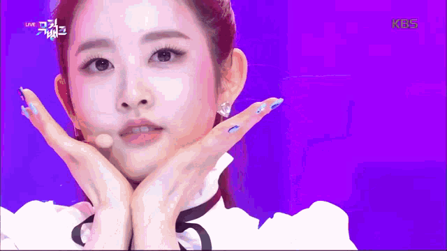 a close up of a woman 's face with a kbs logo on the bottom right