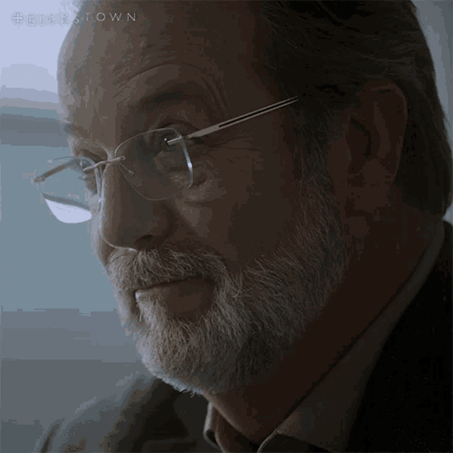 a close up of a man 's face with glasses and a beard with the hashtag #disestown on the bottom