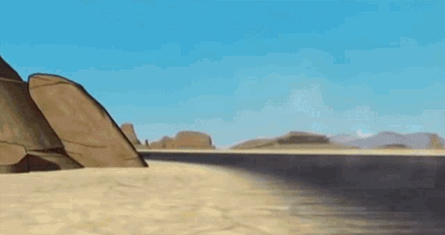 a yellow car is driving down a desert road .