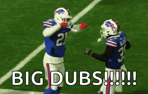 a couple of football players standing on a field with the words `` big dubs '' written on the bottom .