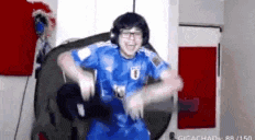 a man wearing a blue jersey and headphones is dancing in a room .