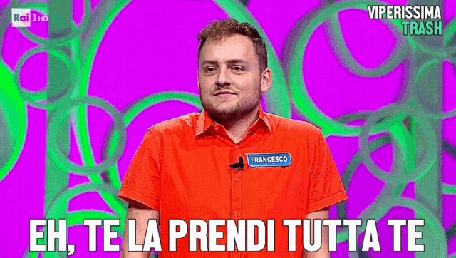 a man in a red shirt with francesco on his name tag says eh te la prendi tutta te