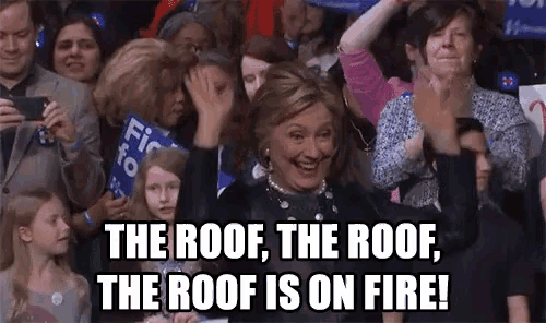 a crowd of people applauding hillary clinton with the caption the roof the roof the roof is on fire .