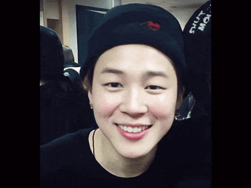 a person wearing a black hat with a red heart on it