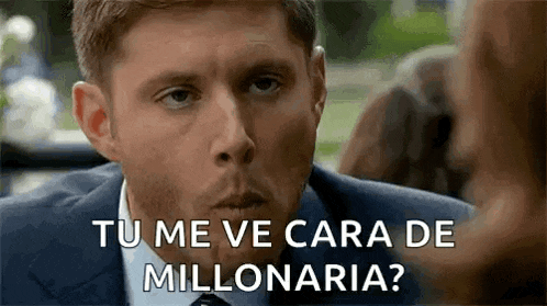 a man in a suit and tie is talking to a woman in spanish .