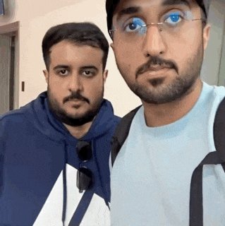 two men with beards are posing for a picture together .