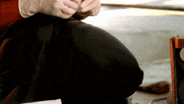 a person wearing gloves is kneeling down and holding something in their hands