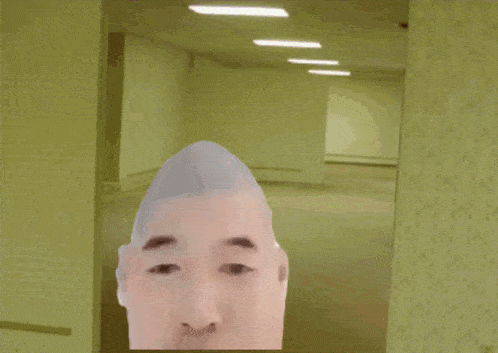 a man with a shaved head is wearing a yellow shirt