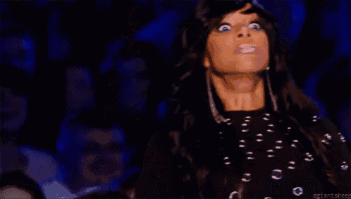 a woman with long black hair is making a funny face while looking up .