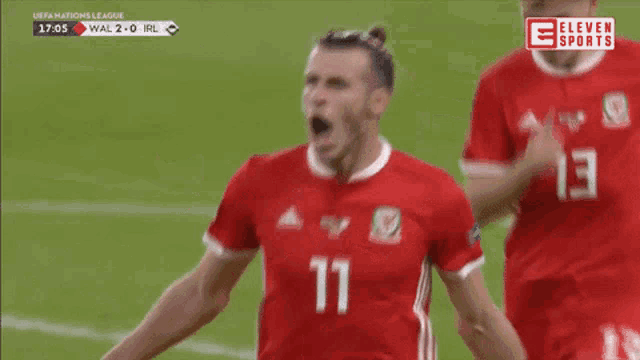 a soccer player with the number 11 on his jersey is celebrating