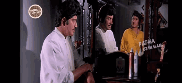 a man in a white shirt is looking at his reflection in a mirror with the words patha cinema on the bottom