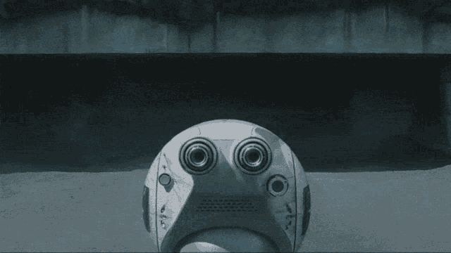 a futuristic looking device with a blue light coming out of it 's eyes