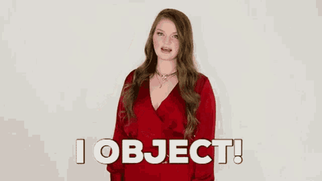 a woman in a red dress is pointing up and saying `` i object ! ''
