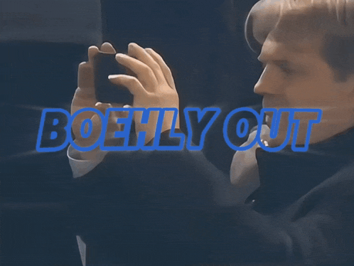 a man taking a picture with the words boehly out in blue letters