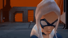 a spider-man and a black cat are standing next to each other .