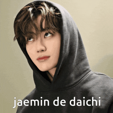 a young man wearing a black hoodie with the words jaemin de daichi written on it