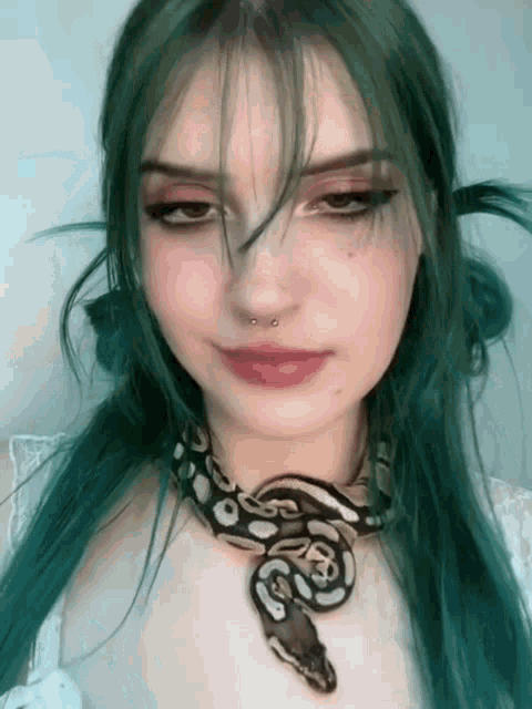 a girl with green hair and a snake around her neck