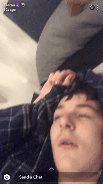 a man laying on a bed with his eyes closed and the words send a chat on the bottom right