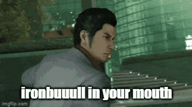 a man in a suit is standing in front of a building with the words `` ironbuuul in your mouth '' written on it .