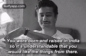 a man is sitting in a chair with a book in his hand and a quote from a movie .