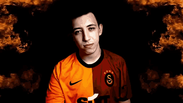 a young man wearing a nike shirt holds his hands to his chest