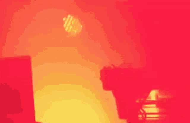 a blurred image of a red wall with a few objects in the foreground