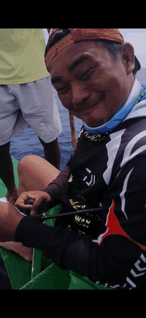 a man on a boat wearing a shirt that says ' td ' on it
